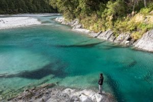 Homem observa as piscinas naturais Blue Pools, na Nova Zelândia